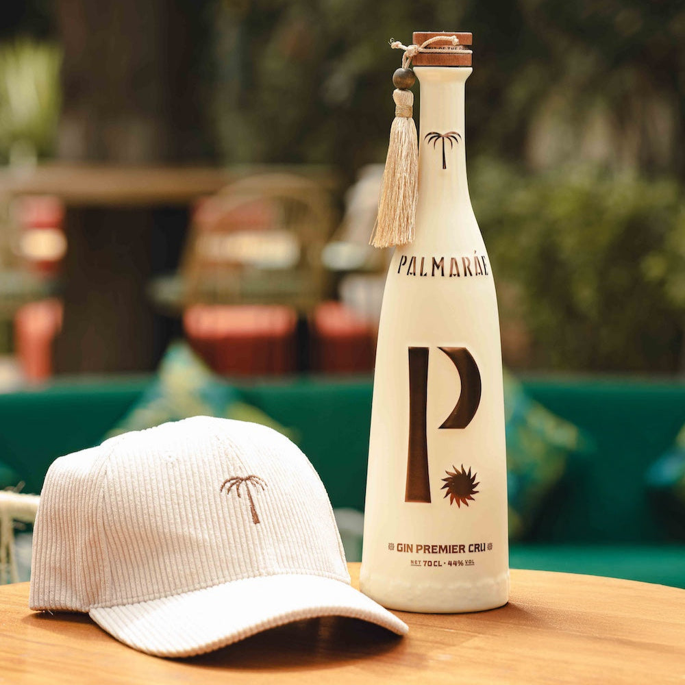 Bottle and cap with a brand logo on a wooden surface